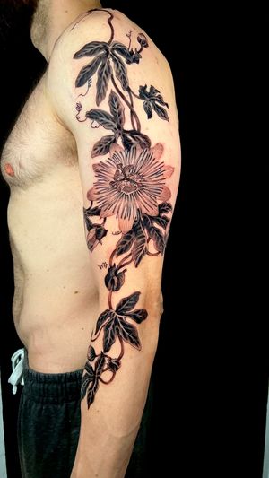 Beautiful upper arm tattoo of a blackwork flower by Kiko Lopes, featuring intricate illustrative design.