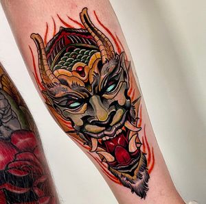 An illustrative Japanese demon tattoo with intricate horns on the forearm by Jethro Wood.