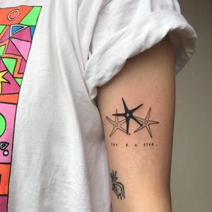 Blackwork star & fine line quote on upper arm, beautifully illustrated by Karyna. Small lettering adds delicate touch.