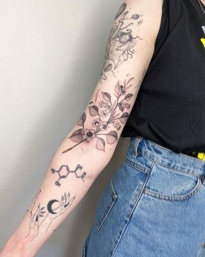 Get a stunning blackwork sleeve tattoo by Kasia featuring intricate ornamental designs of flowers and fruits. Perfect for those seeking a unique and artistic tattoo.