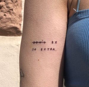 Elegant small lettering tattoo by Karyna, adorning the upper arm with a meaningful quote in fine line style.