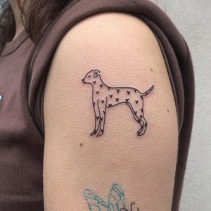 Check out this beautiful illustrative tattoo of a dog and heart by Karyna, perfect for your upper arm!