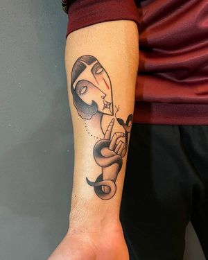 Baingio's bold blackwork intertwines a snake and woman in a stunning illustrative design on the forearm.
