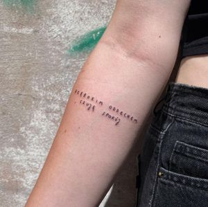 Fine line and small lettering on forearm, featuring a meaningful quote by Karyna.