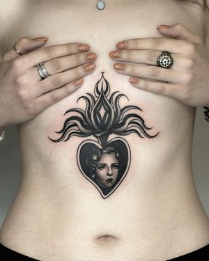 Intricate blackwork illustration of a woman surrounded by flames, symbolizing passion and strength. Done by talented artist Joanna.