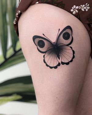 Unique illustrative blackwork butterfly tattoo on upper leg, expertly done by the talented artist Joanna.