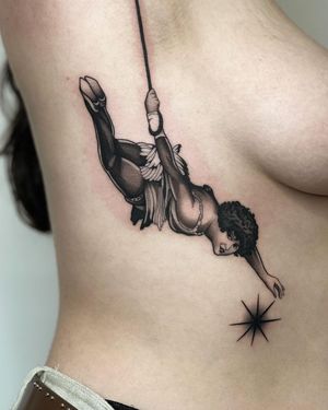 Get a stunning blackwork tattoo on the ribs featuring a woman and a rope design, done by the talented artist Joanna.
