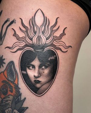 Illustrative tattoo featuring a sun, heart, pattern, and woman, by artist Joanna.