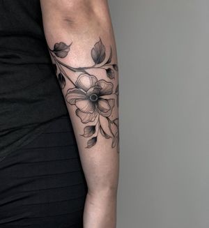 Elegant blackwork design by Joanna featuring a beautiful ornamental flower on the forearm.