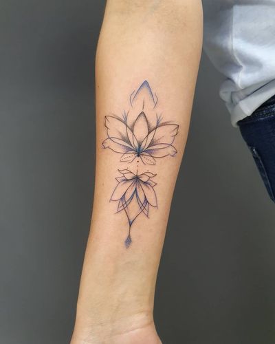 Exquisite blackwork design by Dorota combining fine lines and intricate patterns to create a stunning mandala lotus tattoo.