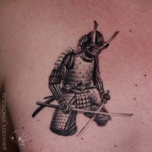 Immerse yourself in the world of samurais with this detailed blackwork tattoo by Slava. Featuring a fierce sword, helmet, and intricate designs.