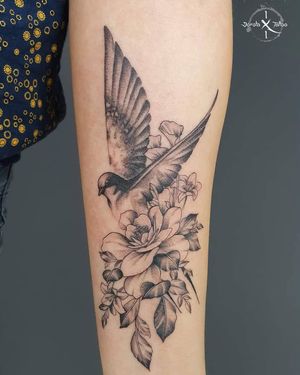 Stunning illustrative design by Dorota featuring a graceful bird and intricate flower, perfect for your forearm.