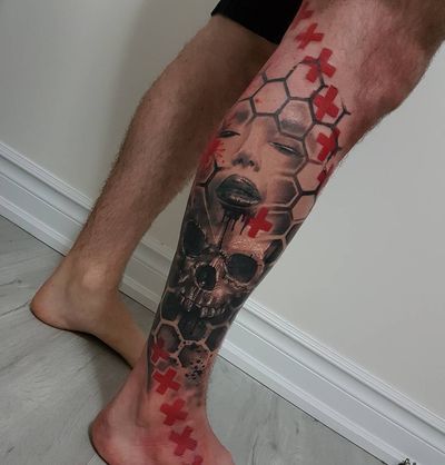 Geometric design featuring a skull, cross, and woman on lower leg by Csaba Sipos, blending blackwork and illustrative styles.