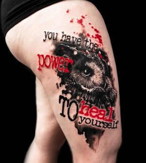 Get a unique mix of trashpolka and realism with Csaba Sipos's intricately designed owl and quote tattoo on your upper leg.