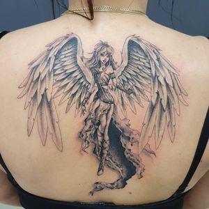 Illustrative back tattoo by Dorota featuring a girl with wings, intricate blackwork design.