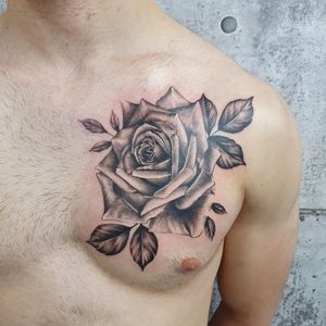 Adorn your chest with a stunning blackwork flower tattoo, expertly done by Dorota in a realistic and illustrative style.