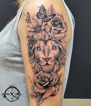 Embrace strength and transformation with this stunning blackwork piece featuring a lion, butterfly, and flower by Dorota.