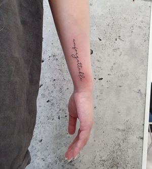 Unique lettering and illustrative design by Dorota, conveying a meaningful message on your forearm.