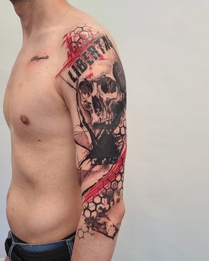 A stunning blackwork sleeve tattoo featuring a skull, intricate patterns, and a meaningful quote, created by the talented artist Csaba Sipos.