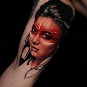Experience the beauty of native culture with this stunning upper arm tattoo of a realistic native woman, expertly done by Slava.