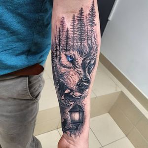 Unleash the power of nature with this stunning tattoo featuring a wolf, bird, tree, and lantern. Designed by the talented artist Dorota.