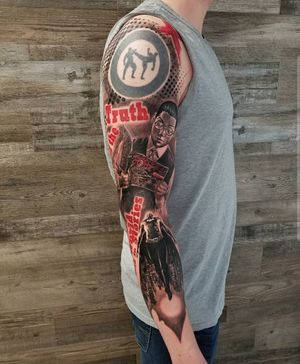 A captivating blackwork sleeve featuring a mix of lettering, trashpolka, and illustrative elements including patterns, a man, journal, newspaper, quote, glasses, and magazine by Csaba Sipos.