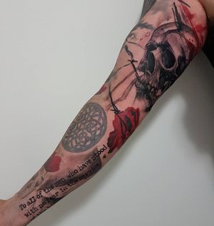 Bold blackwork sleeve featuring flower, skull, and quote with realistic and trashpolka elements by talented artist Csaba Sipos.