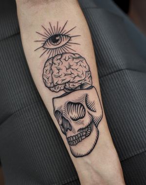 Illustrative tattoo design featuring a skull, eye, and brain in blackwork style on forearm by ALEJANDRO.
