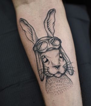Unique blackwork tattoo featuring a rabbit wearing goggles, by artist ALEJANDRO. Perfect for forearm placement.