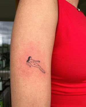 Elegant and intricate fine line tattoo of a woman on the upper arm, expertly done by Sofi. A beautiful and unique addition to your collection.