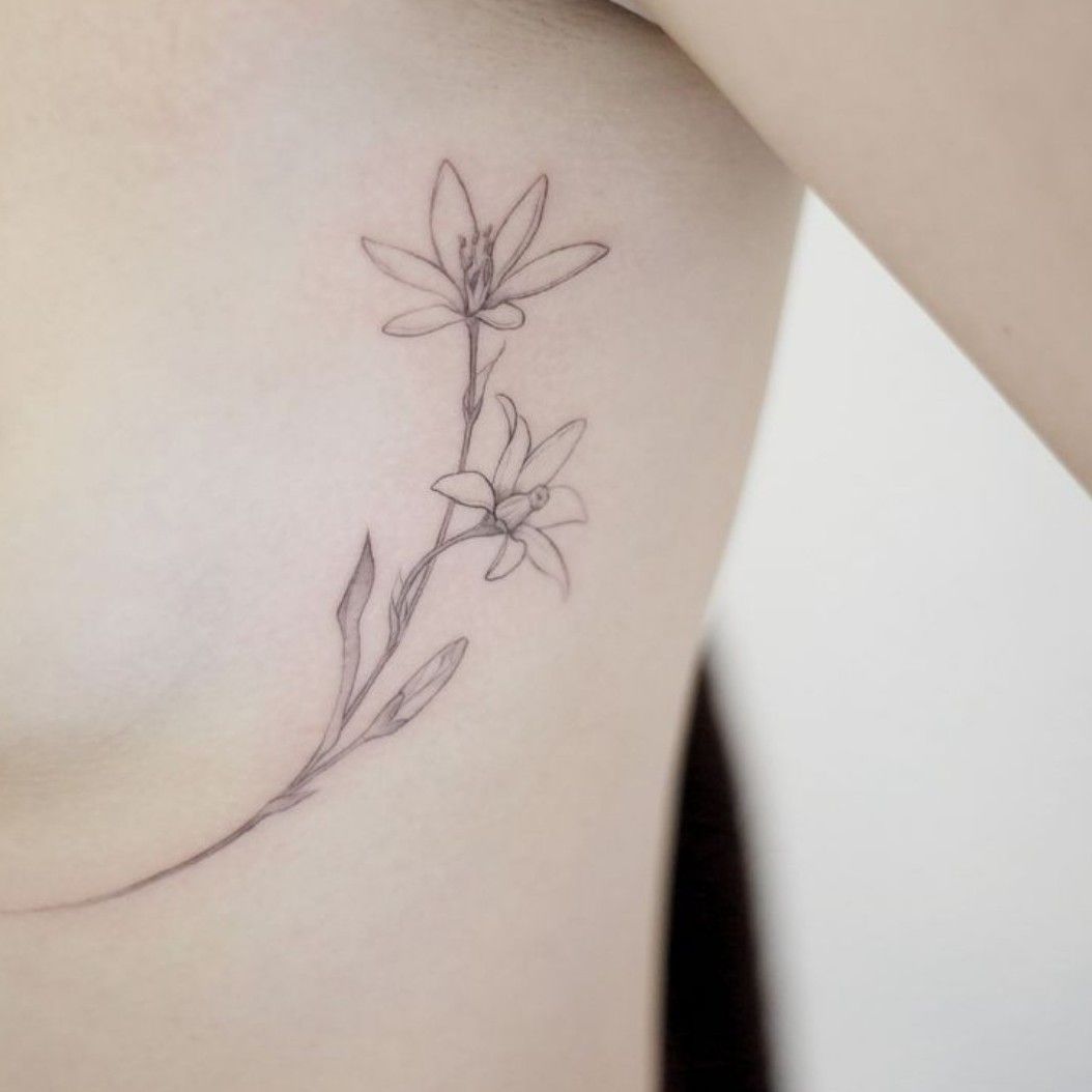 Minimalist lotus flower and north star tattoo on the