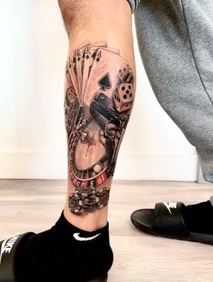 Explore the thrill of the casino with this blackwork and realism tattoo featuring a gun, dice, cards, and cash. By talented artist Dorota.