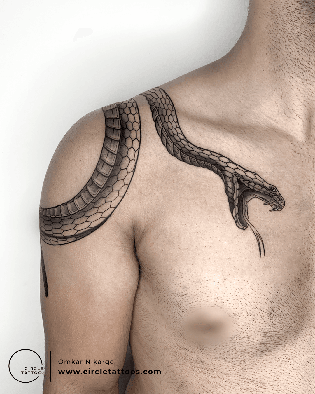 Line art snake tattoo on the top of the shoulder.