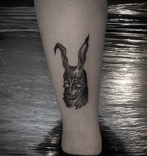 Unique blackwork rabbit tattoo by Shasza, perfect for lower leg placement.