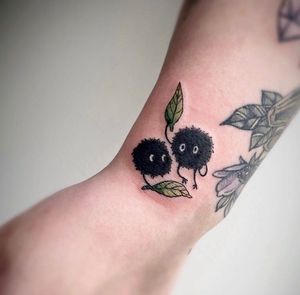 Capture the whimsical world of monsters and nature with this forearm tattoo by Rachel Angharad.