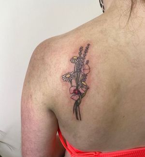 Adorn your upper back with a stunning illustrative flower tattoo by the talented artist Rachel Angharad.