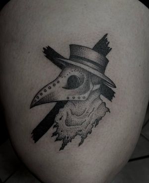 Illustrative upper leg tattoo featuring a cross, hat, and the iconic Dr. Plague character, by Shasza.