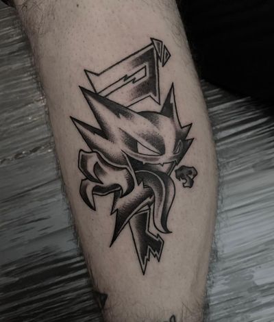 Unique blackwork illustration by Shasza of a mystical Pokemon monster on the lower leg.