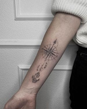 An anchor and compass design with intricate patterns and a meaningful quote, expertly done by Nastya on your forearm.