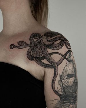 Dive into the depths with this stunning blackwork octopus tattoo by artist Nastya. A unique and intricate design for your shoulder.