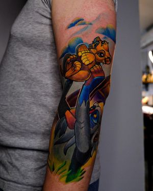Colorful new_school tattoo featuring a playful monkey and fierce lion, expertly illustrated by Denis.