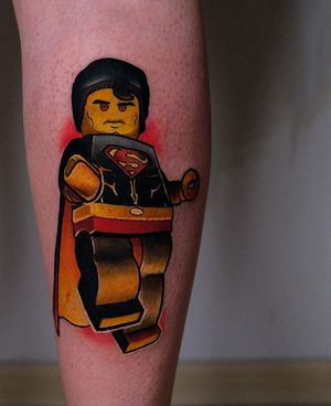 Get an illustrative lower leg tattoo of Super Man in Lego style by artist Denis. A unique blend of two iconic characters!