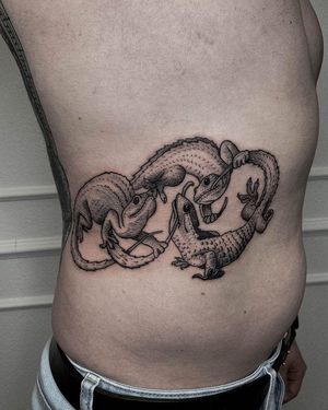 Bold illustrative design by artist Nastya, perfect for a subtle yet striking rib tattoo.