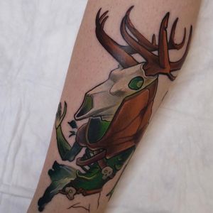 New school style tattoo by Denis featuring a deer skull with horns and skeleton on the forearm