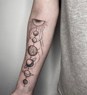 Get lost in the enchanting beauty of this blackwork moon and planet illustration on your forearm. By artist Nastya.