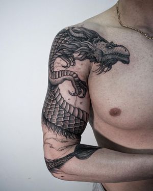 Get mesmerized by Nastya's illustrative dragon design, perfectly inked in bold blackwork style on your upper arm.
