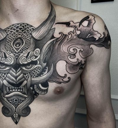 Get a striking blackwork tattoo of devil and hannya masks intertwined with intricate patterns and mandalas on your chest by talented artist Nastya.