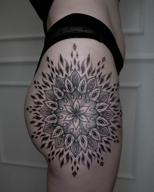 Adorn your upper leg with an intricate dotwork mandala design by talented artist Nastya. A stunning fusion of geometric and ornamental styles.