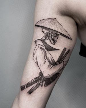 Experience the artistry of Nastya with this bold blackwork tattoo showcasing a skull, samurai, and sword on your upper arm.