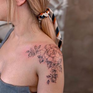 Beautiful blackwork flower design by Liliia on shoulder with intricate details and delicate lines.